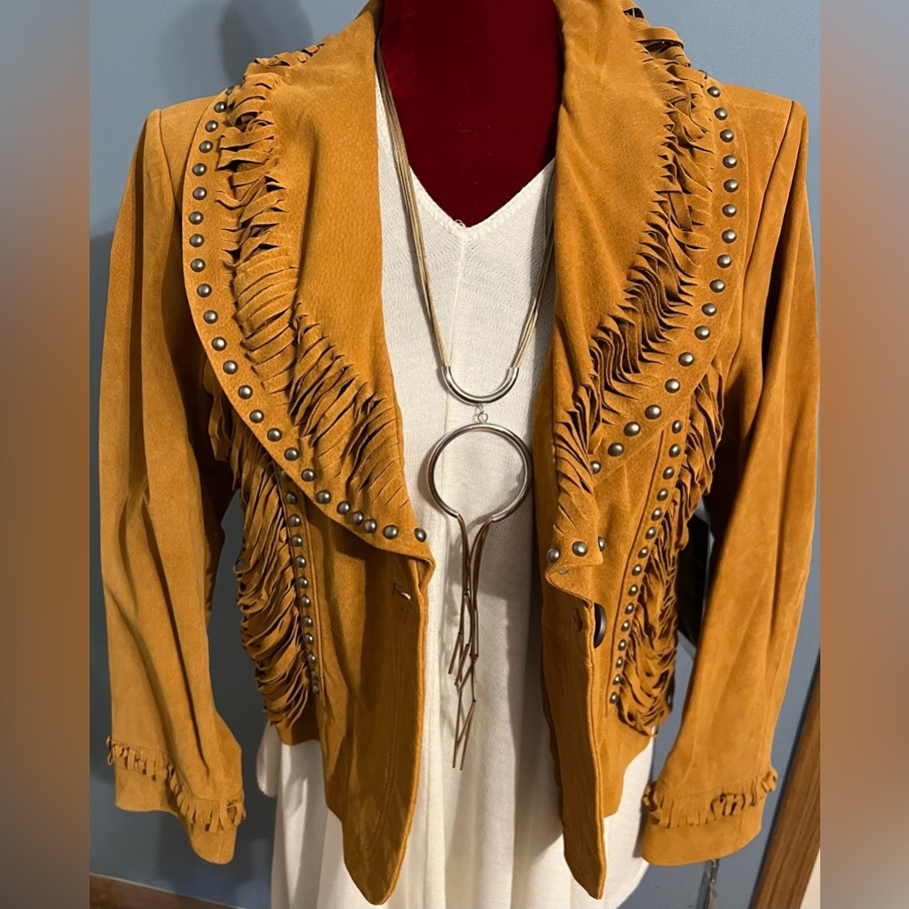 Pamela McCoy Ginuwine leather coat with 100% polyester lining.